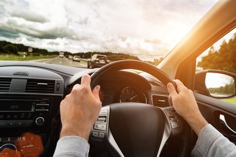 A view of the car dashboard behind the wheel. Learn how to access the advantages of novated leasing using your own vehicle.