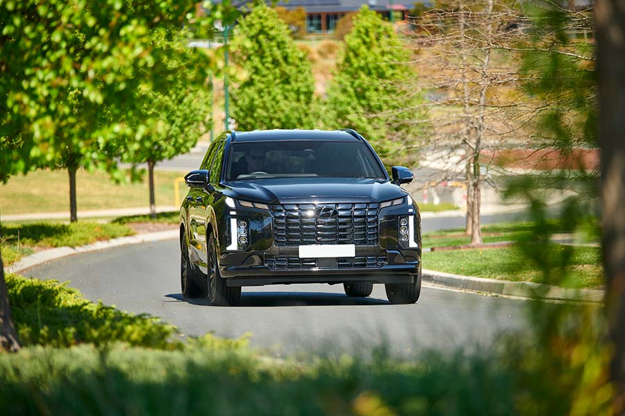 Hyundai Palisade Calligraphy Black Ink 2024 driving on road