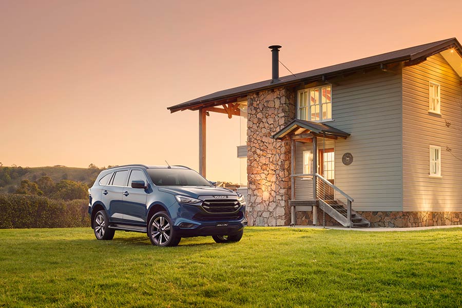 2024 Isuzu MU-X SUV parked in front of house