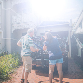 A couple loading their car boot.